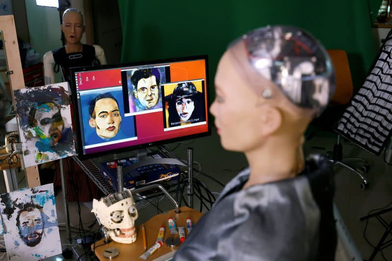 Sophia the humanoid robot, developed by Hanson Robotics, looks at paintings at her studio before auctioning her own non-fungible token (NFT) artwork, in Hong Kong, China March 16, 2021. PHOTO: REUTERS